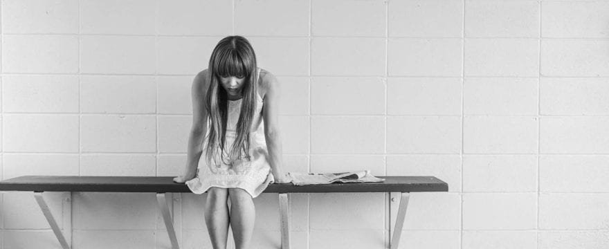 girl sitting on bench struggling to find forgiveness