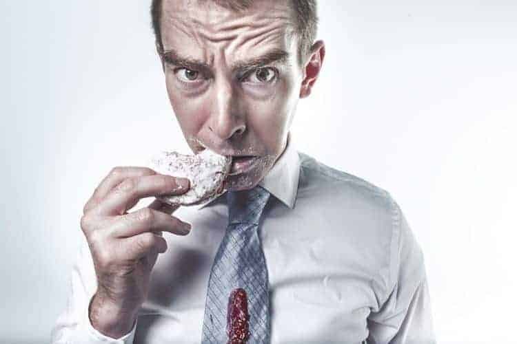 man eating a cookie and tries to weed out negative habits