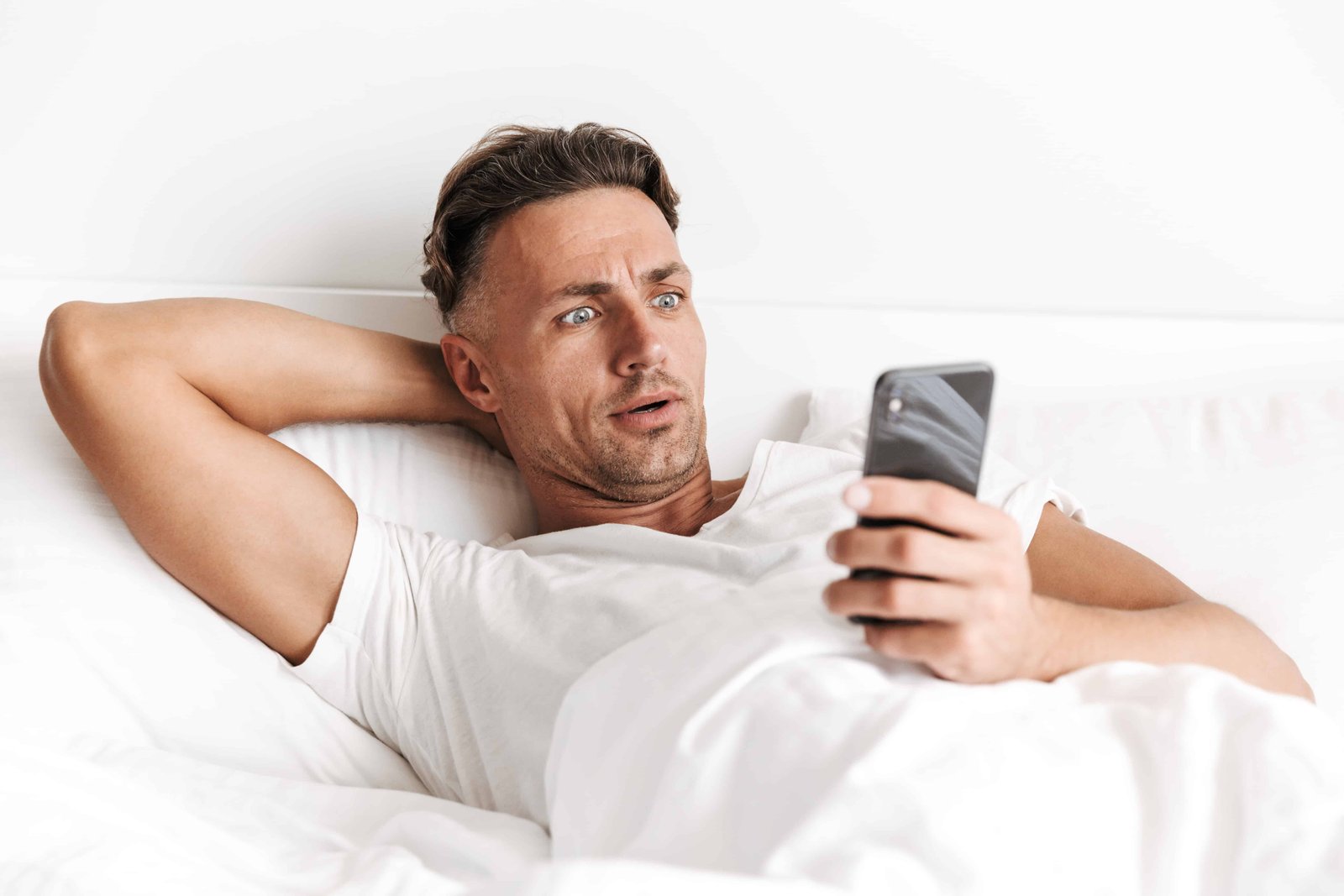 man-in-bed-reading-email-habits