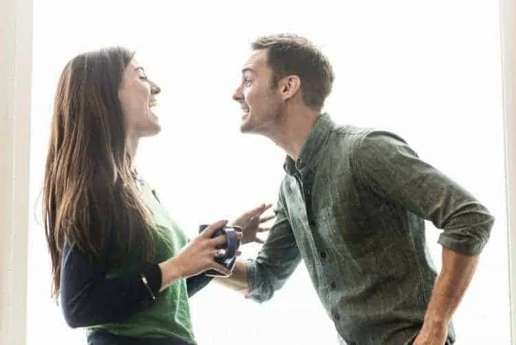 man and woman in office talking over coffee