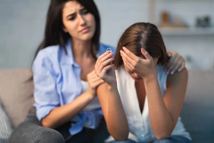 compassionate young woman supporting depressed div 3Q9ECYH end a relationship