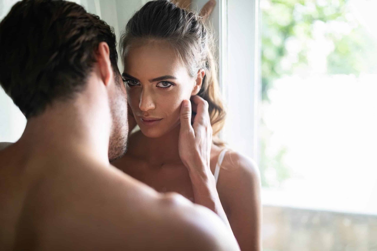 man touches woman's face