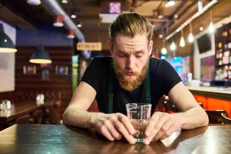 young bearded man getting drunk in bar QL672WB end a relationship
