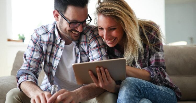 couple shopping online using tablet WSM4QCE