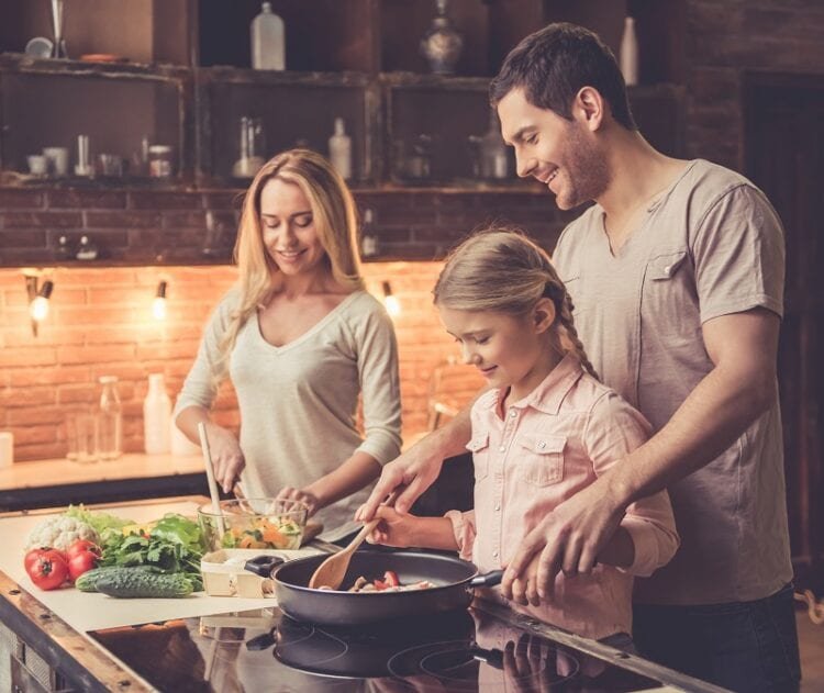 young family cooking UHG6ZGB