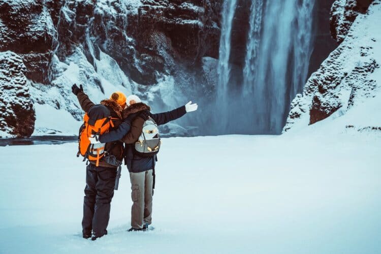 A Healthy Relationship Habits Action Plan 4 Happy couple enjoying amazing view on Skogafoss waterfall, having fun in winter travel to Iceland, active wintertime honeymoon