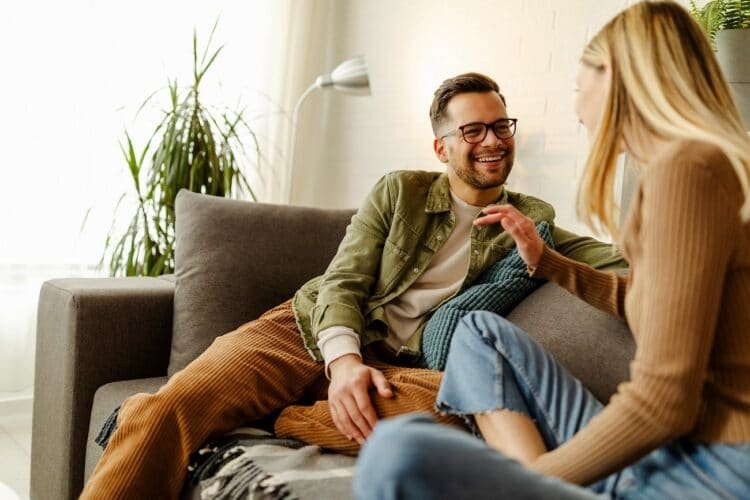 Loving happy couple talking to each other at home.
