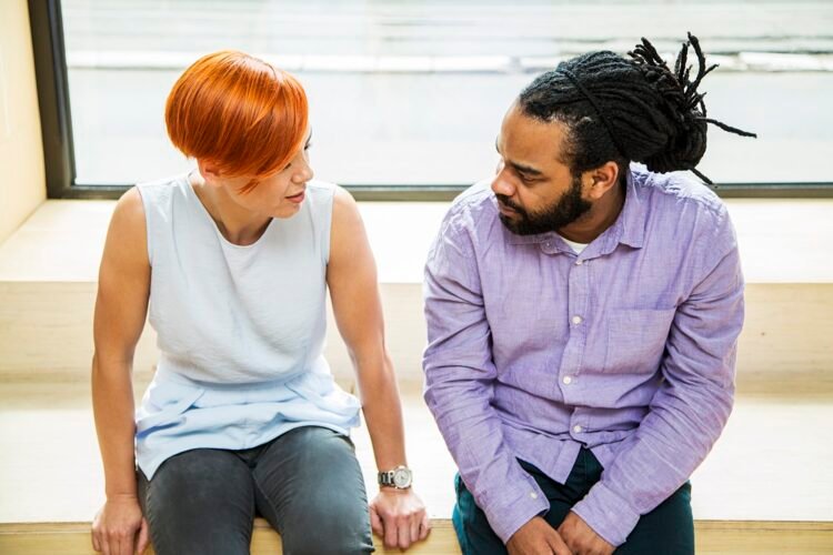 The Key to Constructive Conflict Management: Developing Six Essential Skills 3 Redhaired young woman and black guy talking, Constructive Conflict Management