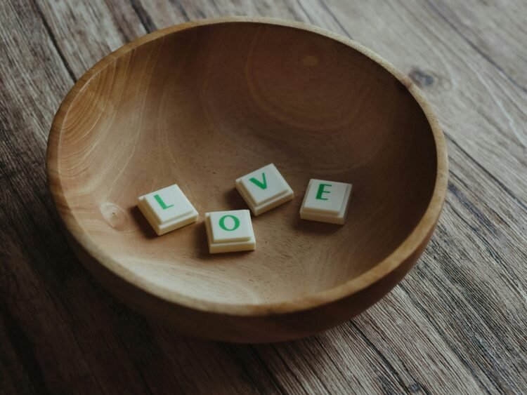 white and brown letter blocks on brown wooden round plate