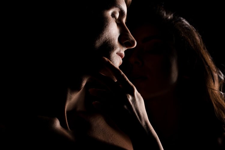 a man and woman in the dark sexual tension