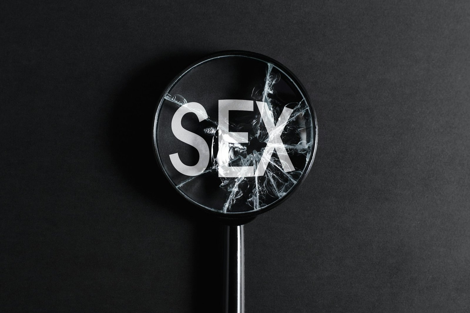 Revitalize Your Relationship: Mastering Sexual Communication for a Thriving Sex Life 1 Concept of lack of sexual life, problems with sex. Close-up of broken cracked magnifier focused