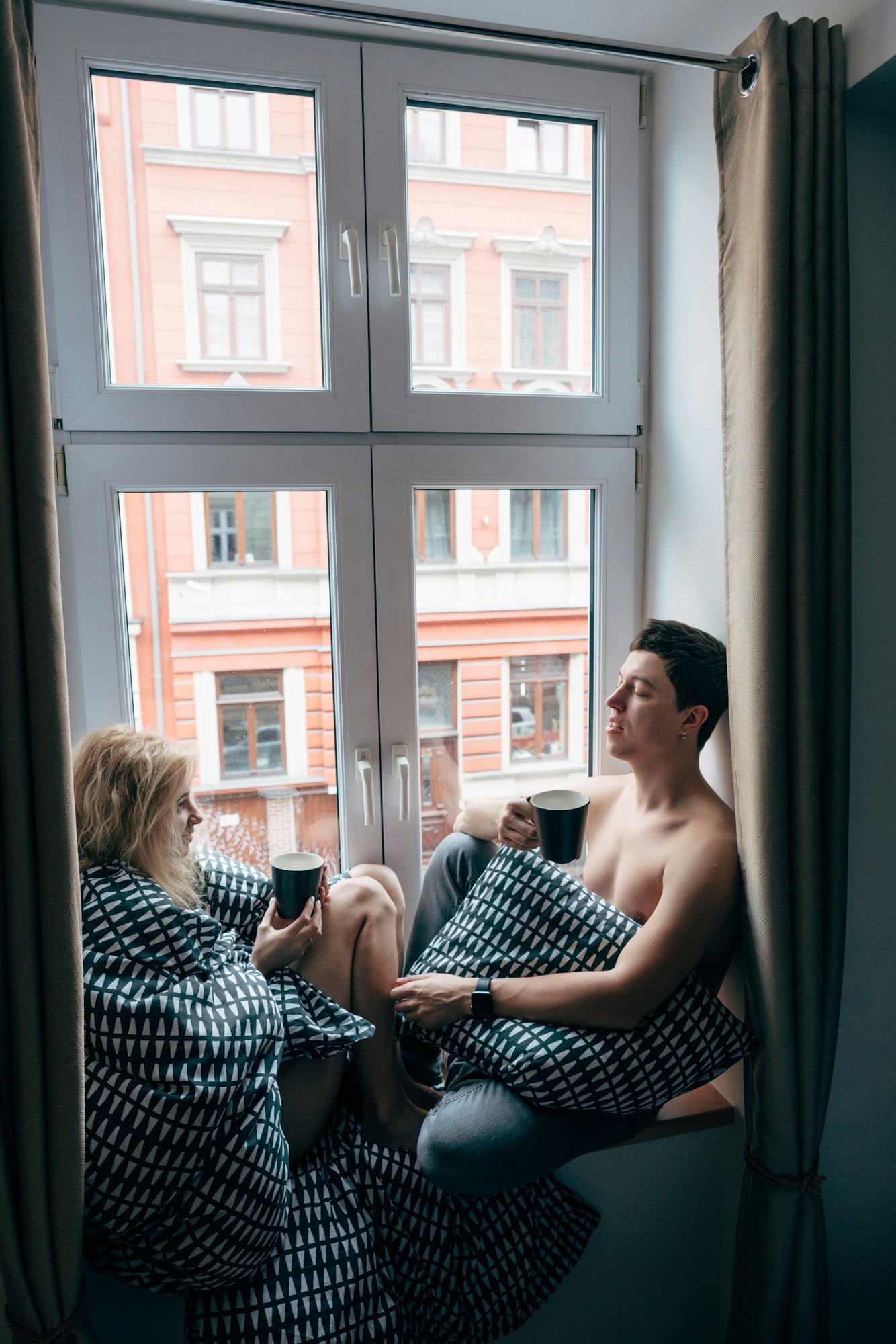 Man and beautiful girl while sitting by the window