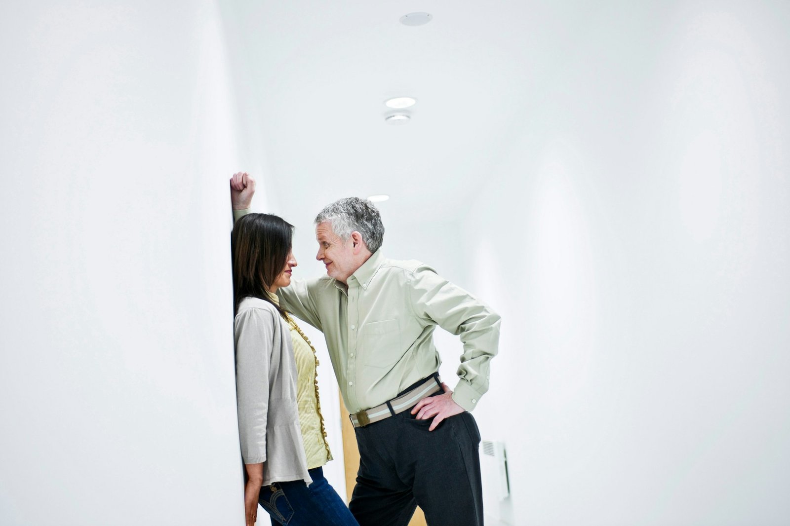 suggestive couple in corridor