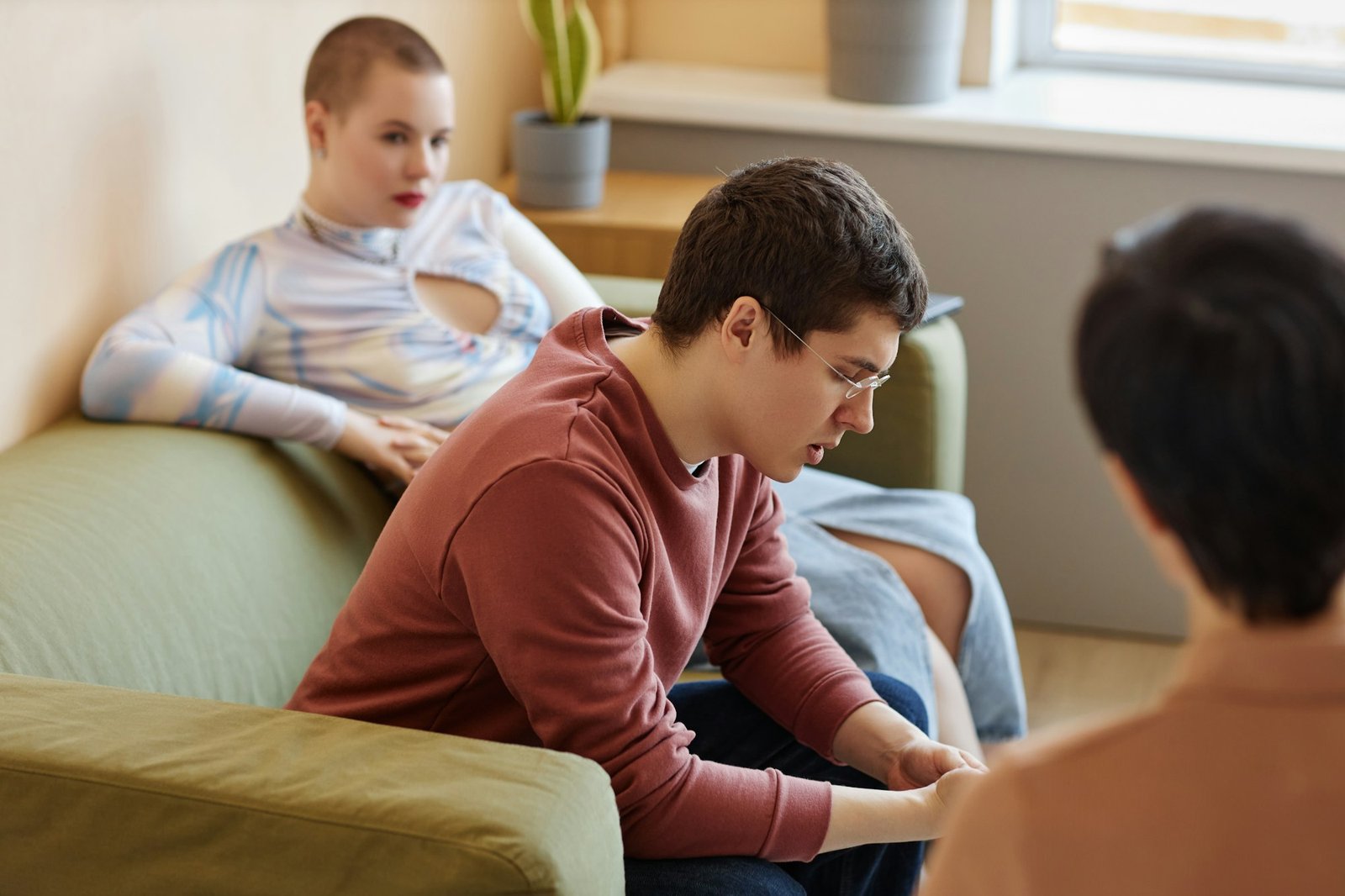 Young couple discussing problems with psychologist