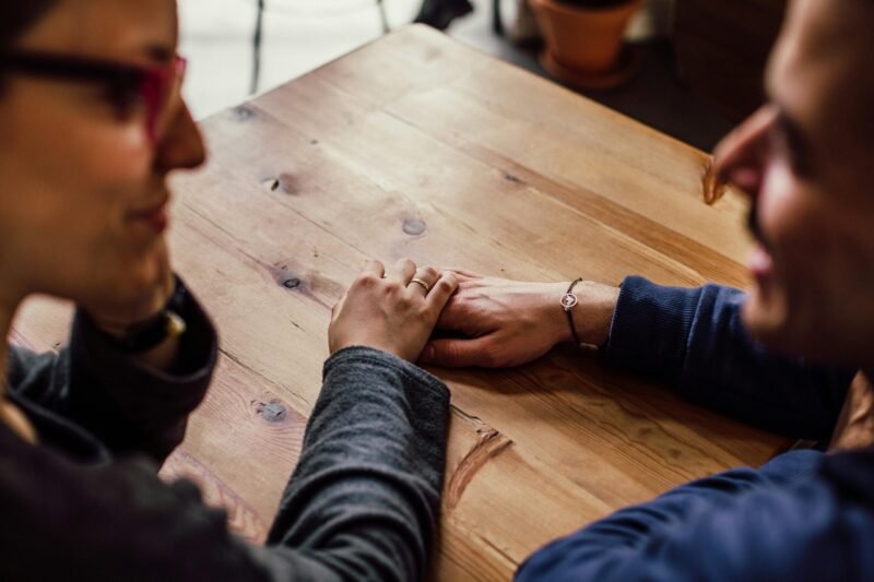 Man and woman sitting together in front of table