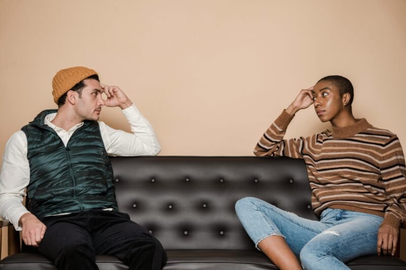 Serious multiethnic couple on couch