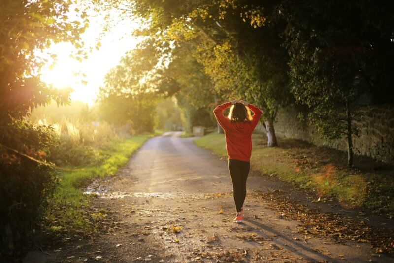 married woman walking on pathway during daytime